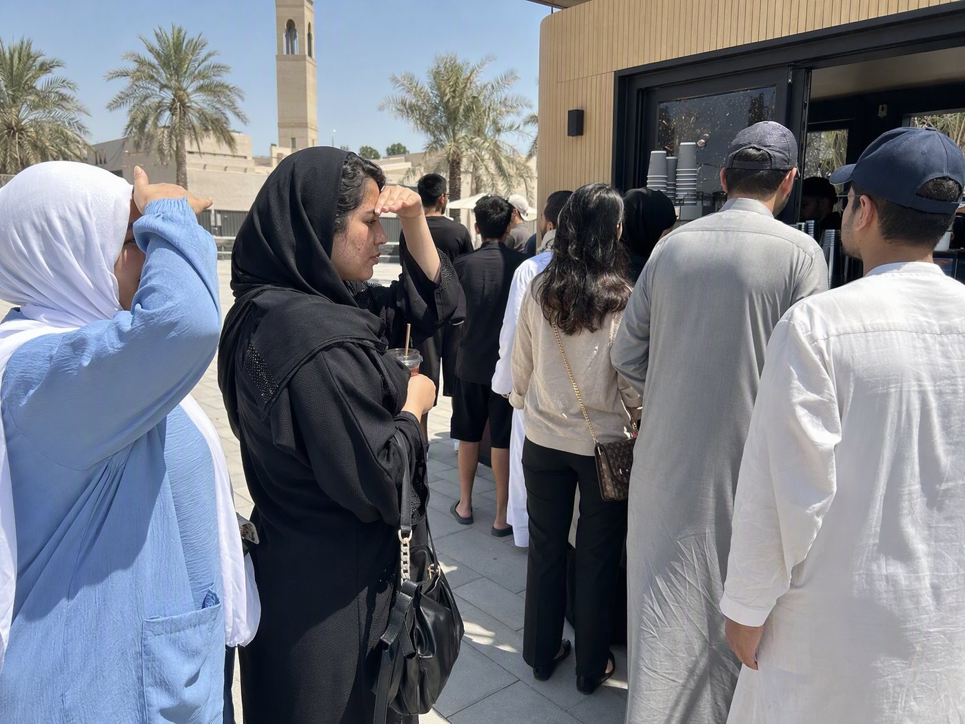 A coffee queue in the midday sun